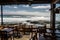 beachside eatery with view of rolling waves and sunny skies