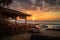 beachside eatery with view of sunset, warm colors and gentle waves