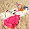 Beachwear  handbag women accessories summer beachwear hat sneakers red dress sunglasses and cup of coffee on yellow towel on sand