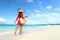 Beachwear woman walking with sun hat and beach bag