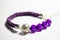 The bead and cord bracelet is purple. Women`s bracelet with beads and wicker. Jewelry made of beads. Jewelry for luxury women