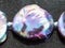 Bead from Haliotis gemstone on dark background