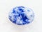bead from Lapis lazuli gemstone on white marble