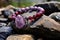 beaded bracelet draped over a rough granite boulder