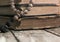 Beads lying on shabby battered old book lying on the old cracked