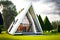 beaful modern house with triangle roof with flat paths and lawns