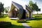 beaful modern house with triangular roof, green lawn and comfortable paths