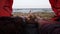 Beaitiful scene of relaxed youg couple have a rest in the tent and looking on the sea or ocean. Close up of feet