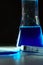Beaker and retort with blue with a chemical reagent. Chemical experiment with Laboratory glass