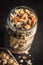 Beakfast cereals in jar. Healthy muesli with oat flakes, nuts and raisins