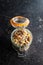 Beakfast cereals in jar. Healthy muesli with oat flakes, nuts and raisins