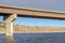 Beam bridge with abutment foundation against rugged land and cloudy sky