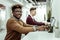 Beaming African American guy in clear glasses working on laptop