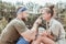 Beaming bearded man touching nose of his girlfriend spending day in nature