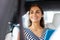 Beaming businesswoman smiling while sitting in car