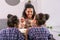 Beaming curly dark-eyed mother taking care of her cute girls in cafeteria