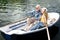 Beaming elderly lady posing for photo with her husband in boat