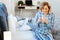 Beaming good-looking mature lady sitting on the bed in bright pajama