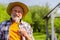 Beaming grey-haired retired man smiling while holding dandelion