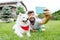 Beaming handsome man making selfie with his white husky