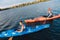 Beaming handsome sportsman a rowing in canoe