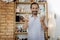 Beaming inspired man working in his workroom making vases