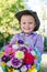 Beaming little boy with flowers for his mother