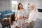 Beaming mother and grandmother cooking together with little girl