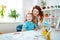 Beaming mother laughing while sitting near computer with daughter