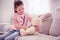 Beaming pleasant preschooler playing with her teddy bear in living room