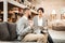 Beaming positive couple spending time in furniture store