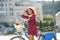 Beaming student standing near bike after making groceries