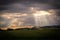 Beams of sunlight coming through evening clouds in Scotland