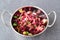 Beans,beetroot, sauerkraut, pickles. Boiled vegetables with olive oil in a metal bowl on a grey abstract background