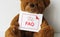 Bear doll with an FAQ card