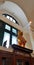 Bear doll standing on children fiction book wooden cabinet in the library