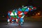 Bear garland. Multi-colored sparkling electric New Year Christmas bear on snow at night. Installation figure