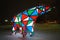 Bear garland. Multi-colored sparkling electric New Year Christmas bear on snow at night. Installation figure