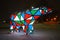 Bear garland. Multi-colored sparkling electric New Year Christmas bear on snow at night. Installation figure