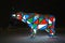 Bear garland. Multi-colored sparkling electric New Year Christmas bear on snow at night. Installation figure