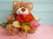 Bear teddy toy with tulips on a wooden