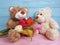 Bear toy with tulips, birthday on a wooden background