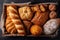 Beard, buns, muffins, bread loaves, bread rolls and pastry in a wicker basket, top view, flat lay