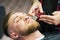 Beard care. man while trimming his facial hair cut at the barbershop