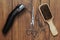 Beard grooming accessories on a luxury wooden surface.