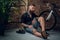 Beard male realaxing on a floor with bicycle on background.