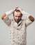 Beard man portrait in knitted sweater hands on hair