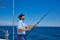 Beard sailor man fishing rod trolling in saltwater