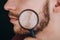 Beard under a magnifying glass. hairline on a man`s face close up. portrait of a guy with a mustache