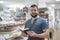 Bearded 35 years old man looking book in library and crafts store